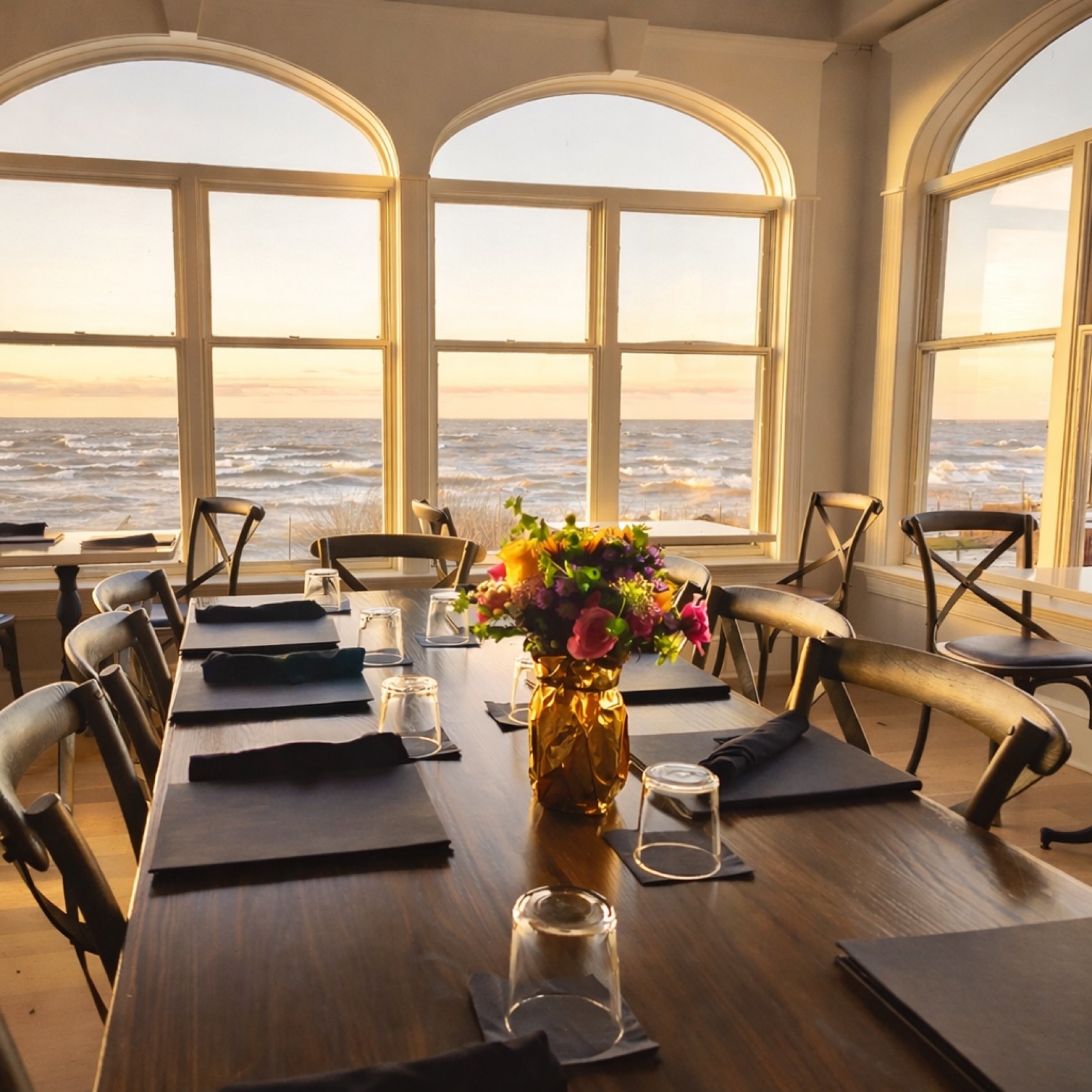 A long table set under the arched windows