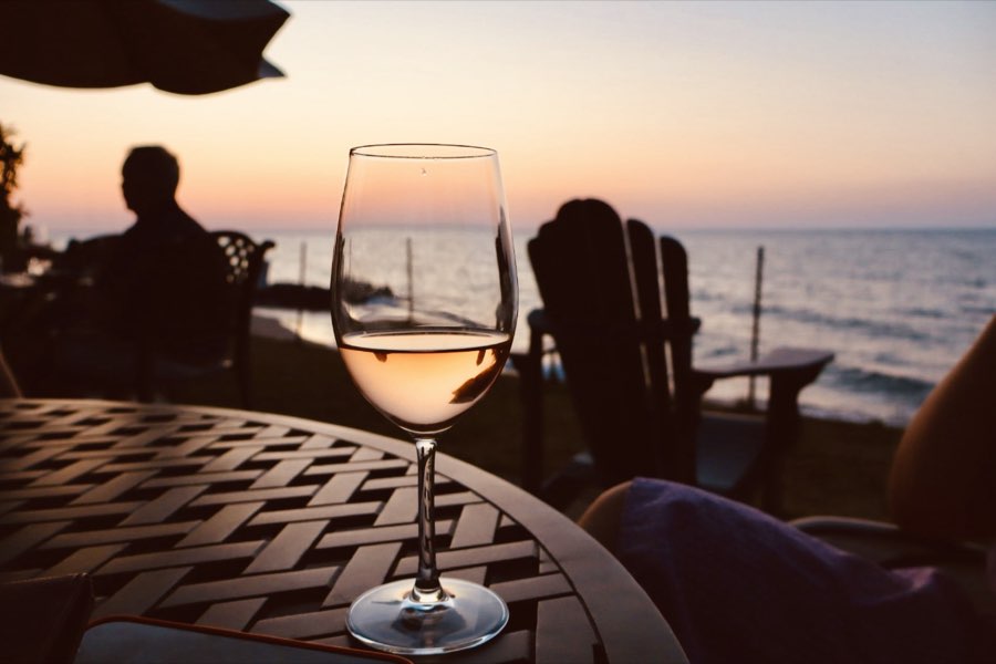 A glass on the lawn above the beach at sunset