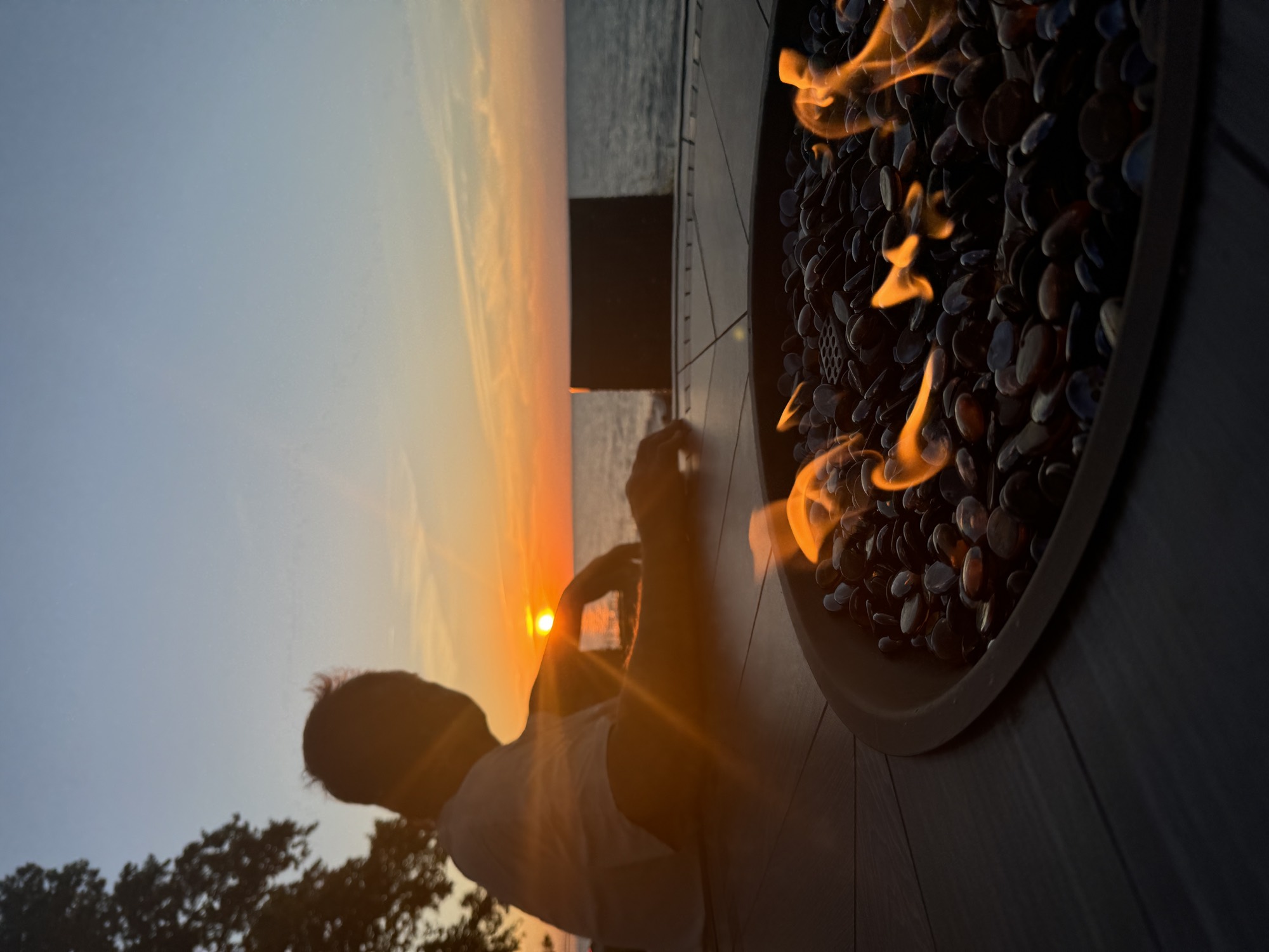 A firepit at sunset over the lake
