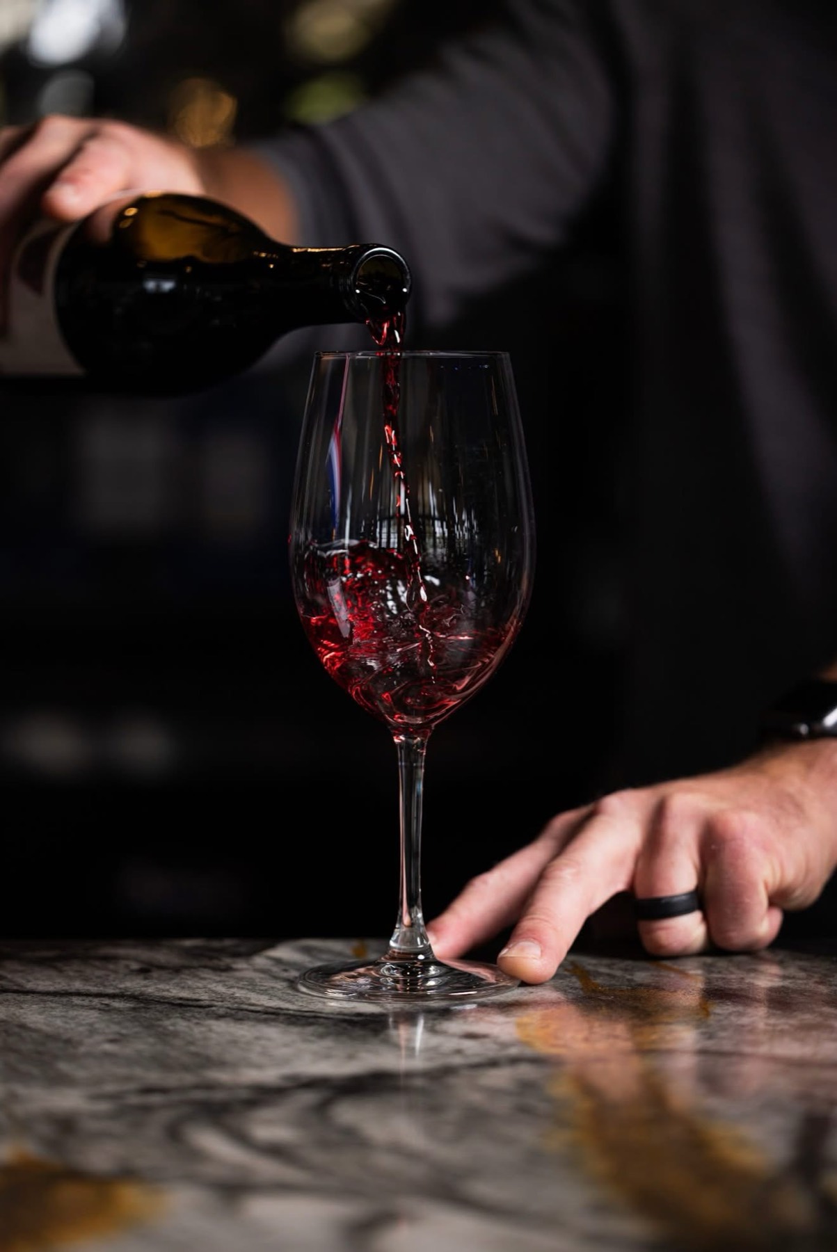 A glass of estate red being poured
